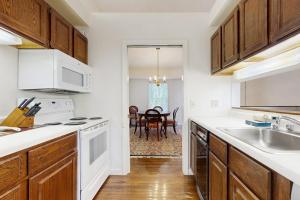 a kitchen with white appliances and a dining room at Dog-Friendly Townhouse w/Bay Views, Fast WiFi, and Partial A/C in Bar Harbor