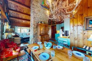 a living room with a wooden table and a dining room at Riverfront retreat with a furnished deck, washer/dryer & fast WiFi in Boothbay +24 photos