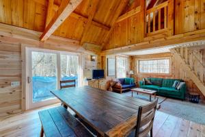 a dining room with a wooden table in a cabin at Cozy woodsy Cabin w/ a Deck, Firepit, Gas Grill, Free WiFi, & Full Kitchen in Greenville +12 photos