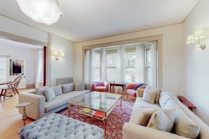 a living room with two couches and a glass table at Beautiful home with Ping-Pong, fast WiFi & W/D - walk to dining in Wiscasset