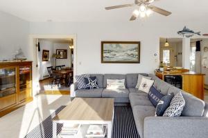a living room with a couch and a table at Oceanfront house with dock, kayaks, deck, and gas grill in Boothbay Harbor
