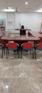 a wooden table with four chairs in a room at OABY'S Hôtel in Bobo-Dioulasso