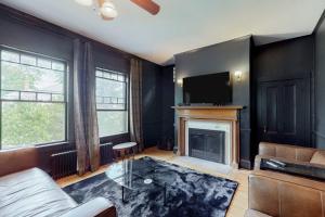 a living room with a couch and a fireplace at Beautiful home with Ping-Pong, fast WiFi & W/D - walk to dining in Wiscasset