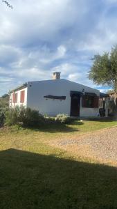 a large white building with a tree in front of it at Armonía in Villa Serrana