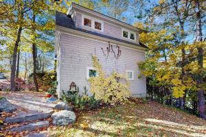 a white house with graffiti on the side of it at Charming coastal cottage with firepit and easy beach access in Rockport