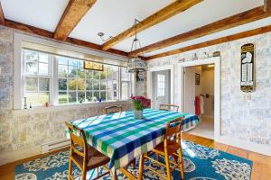 a dining room with a blue and white table and chairs at Charming Seaside Cottage with a Gas Fireplace, Spacious Patio, and Nearby Hiking in Hancock
