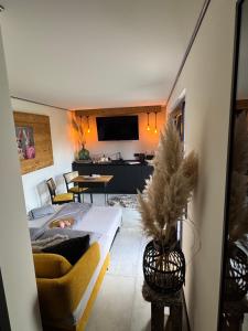 a living room with a couch and a table at Secret Garden Spa House - Pool & Sauna in Großenlüder