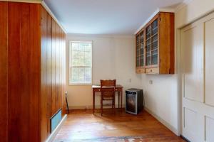 a room with a table and a chair and a kitchen at All-suite Boothbay Harbor home with deck, ocean views, and fireplaces in Boothbay Harbor