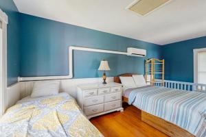 two beds in a room with blue walls at Dog-Friendly House with WiFi and Deck - Near the Water, Eateries, and Shopping in Bar Harbor