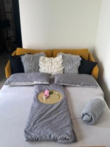 a bed with pillows and a plate with a flower on it at Secret Garden Spa House - Pool & Sauna in Großenlüder +58 photos