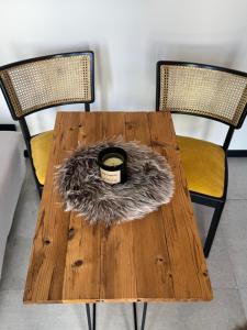 a wooden table with two chairs and a candle on it at Secret Garden Spa House - Pool & Sauna in Großenlüder
