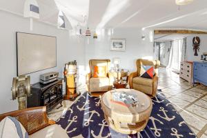 a living room with a table and chairs at Multi-unit with oar & boat house with private dock & kayaks in Boothbay Harbor