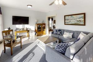 a living room with a couch and a tv at Oceanfront house with dock, kayaks, deck, and gas grill in Boothbay Harbor