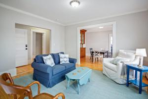 a living room with a blue couch and a table at Waterfront, walkable, updated home with harbor views & partial AC in Camden