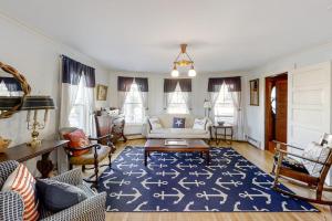 a living room with a couch and a blue rug at Multi-unit with oar & boat house with private dock & kayaks in Boothbay Harbor +45 photos