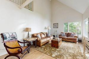 a living room with a couch and a chair at Oceanfront snowbird-friendly home on the beach with washer/dryer & fireplace in Lincolnville