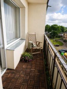 a balcony with a bench and a window at Family Nest in Ventspils