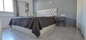 a bedroom with a large bed in a room at Torres del Sol-La Perla- Beachfront & Ocean View in Los Cristianos +52 photos