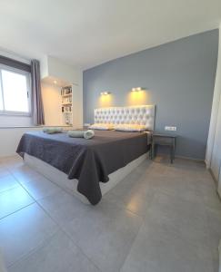 a bedroom with a large bed in a room at Torres del Sol-La Perla- Beachfront & Ocean View in Los Cristianos