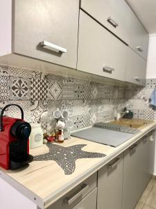 a kitchen with white cabinets and a counter top at Mitso's Talo in Samos +10 photos