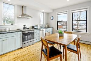 a large kitchen with a wooden table and chairs at Waterfront, walkable home with beautiful kitchen & washer/dryer - dog-friendly in Camden