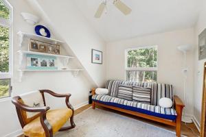 a living room with a couch and a chair at Oceanfront snowbird-friendly home on the beach with washer/dryer & fireplace in Lincolnville