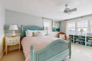 a bedroom with a bed and a ceiling fan at Oceanfront home incredible ocean views, deck & location in Boothbay +13 photos