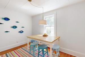 a dining room with a table and blue chairs at Tranquil Seaside Cottage with Spectacular Views, Wifi & Washer/Dryer in Boothbay