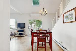 a dining room with a table and chairs at Oceanfront snowbird-friendly home on the beach with washer/dryer & fireplace in Lincolnville