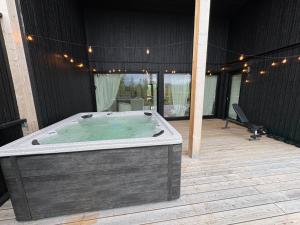 a large hot tub sitting on a deck at Sunrise View Lapland, Jacuzzi and sky view in Kilpisjärvi