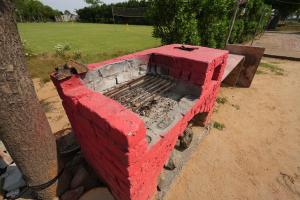 a brick wall with a red brickburning at Rupani Dhani Farmhouse by Belmore in Mandkaula