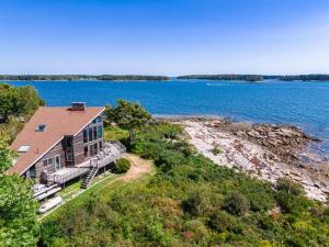 a large house on the shore of a body of water at Clark Point Cottage, ocean access, panoramic views in Clark Island