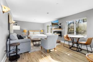 a bedroom with a bed and a living room at Mabel's Maine Studio on the River in Edgecomb