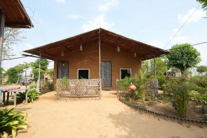 a small house with a fence around it at Rupani Dhani Farmhouse by Belmore in Mandkaula