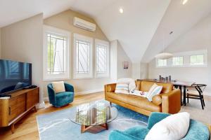 ein Wohnzimmer mit Sofa und Tisch in der Unterkunft Stunning riverfront home, hot tub, BBQ, and washer & dryer in Edgecomb + 17 Fotos