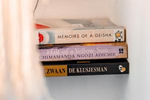 three books stacked on top of each other on a wall at Ca Nikte Cabañas in El Cuyo