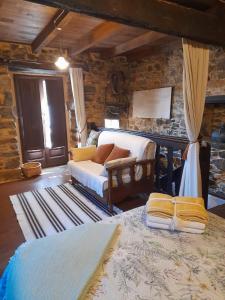 a bedroom with a bed and a couch in a room at Vega in Muñás