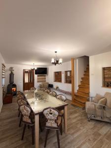 a living room with a table and chairs and a couch at Casa Todor Fundata in Fundăţica