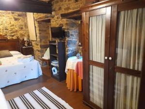 a bedroom with a bed and a table in a room at Vega in Muñás