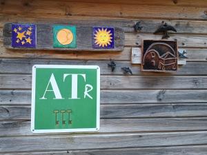 a sign that reads atr hanging on a wooden wall at Vega in Muñás +4 photos