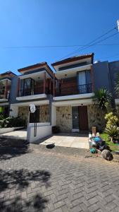 a large house with a driveway in front of it at A-Three Guest House in Malang