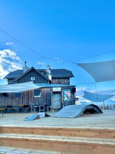 a building with a ramp in front of it at Speiereckhütte in Mauterndorf