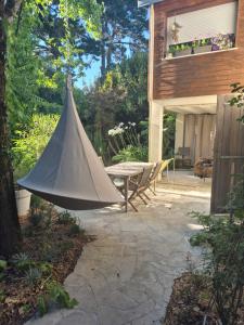 a tent hanging from a tree in a patio at La Biro in Pornic