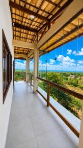 an empty porch with a view of a field at Pousada Recanto do Luar in Serra de São Bento
