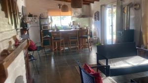 a kitchen with a table and chairs and a refrigerator at Armonía in Villa Serrana