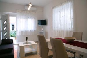 a living room with a table and a dining room at Porta Anna Apartments in Medulin