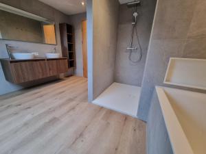a bathroom with a shower and two sinks and a tub at Val du Roannay in Stavelot +18 photos