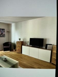 a living room with a flat screen tv on a cabinet at Bellavista in Bern +14 photos