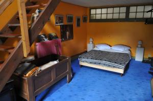 a bedroom with a bed and a bunk ladder at Chambre d'hôtes Erziwezh in Sainte-Marie