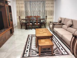 a living room with a couch and a table and chairs at Dani's Sea Breeze in Oran